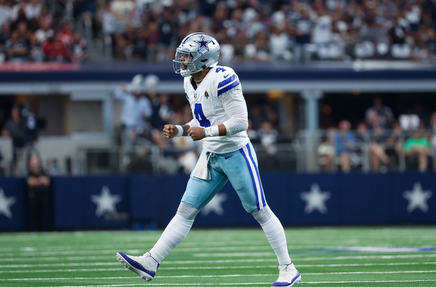 Dallas Cowboys quarterback Dak Prescott reacts after throwing a touchdown pass.